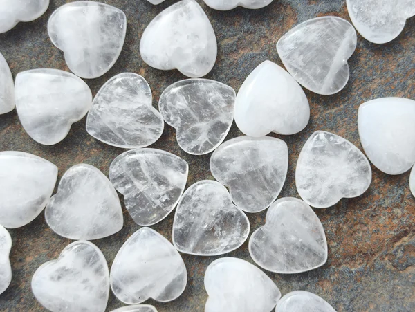 Cuarzo transparente pulido natural dispuesto en conjunto sobre superficie de piedra